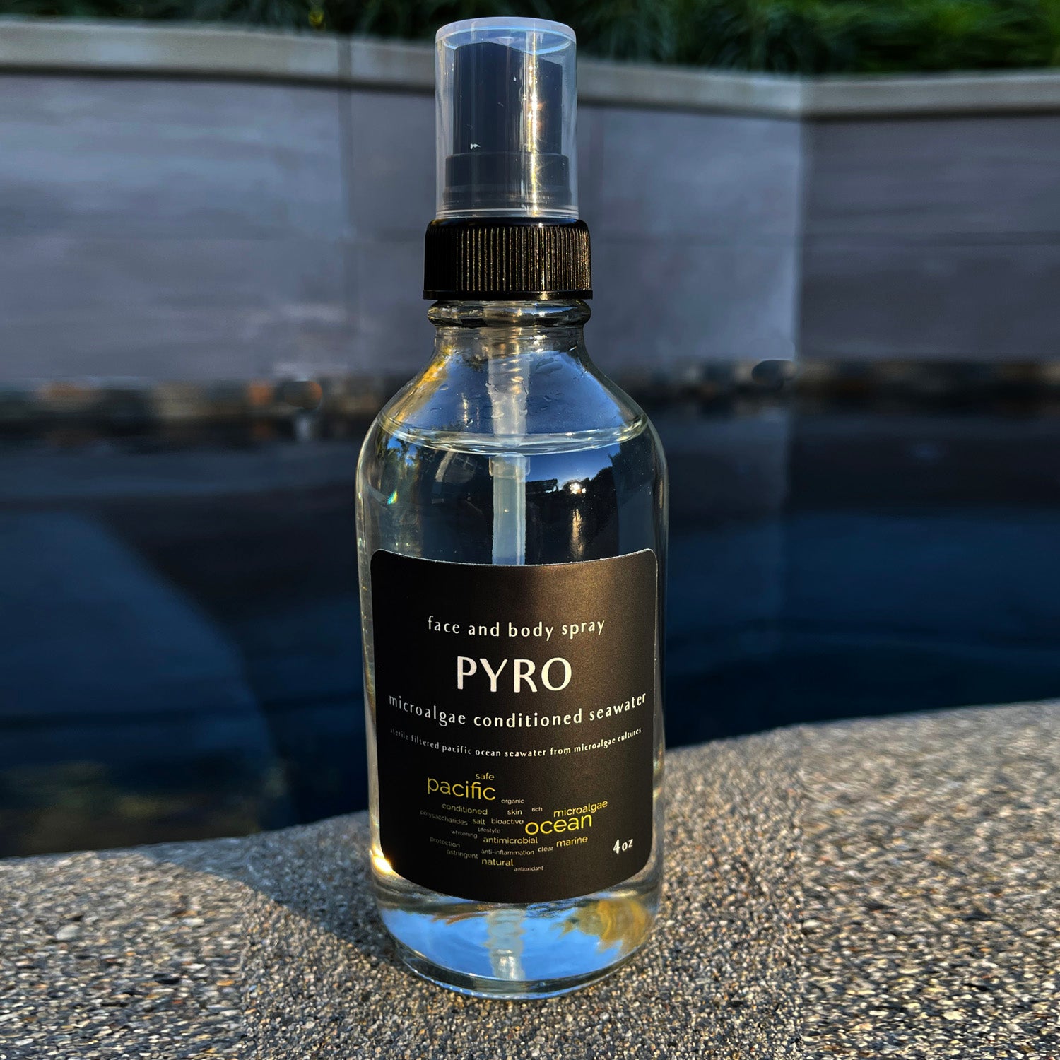 Eco-friendly PYRO Ocean Spray bottle with natural lighting and sea elements